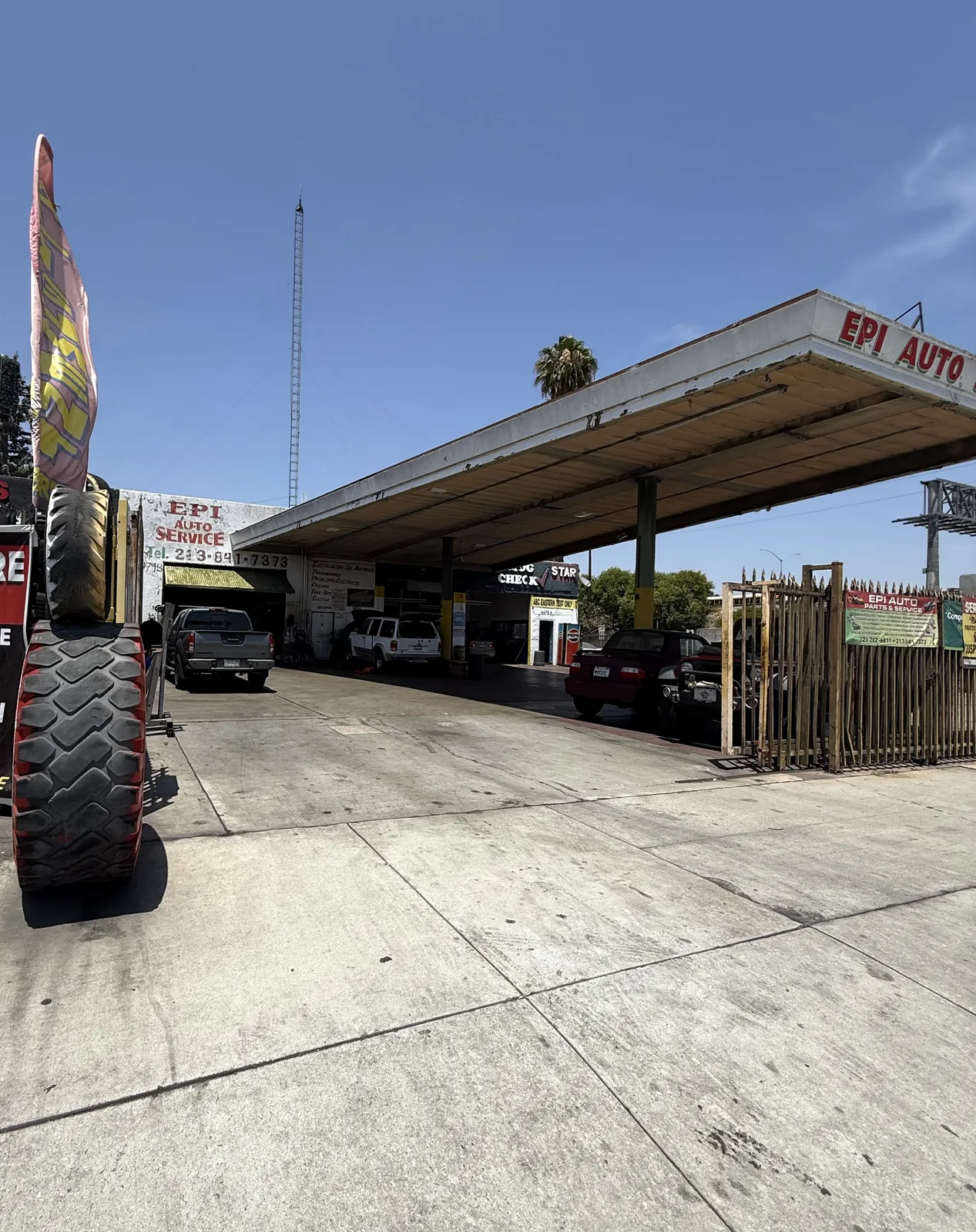 EPI Auto Service storefront on Olympic Boulevard in East LA — covered service canopy, painted shop sign and customer vehicles in the bays